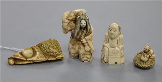 A Japanese carved ivory netsuke of a woman carrying a bundle, a netsuke formed of stylised fruit and leaves (4)